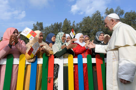 Pope Francis greets women during a visit to a rural social service run by the Daughters of Charity of St. Vincent de Paul in Temara, near Rabat, Morocco March 31, 2019. Vatican Media/­Handout via REUTERS