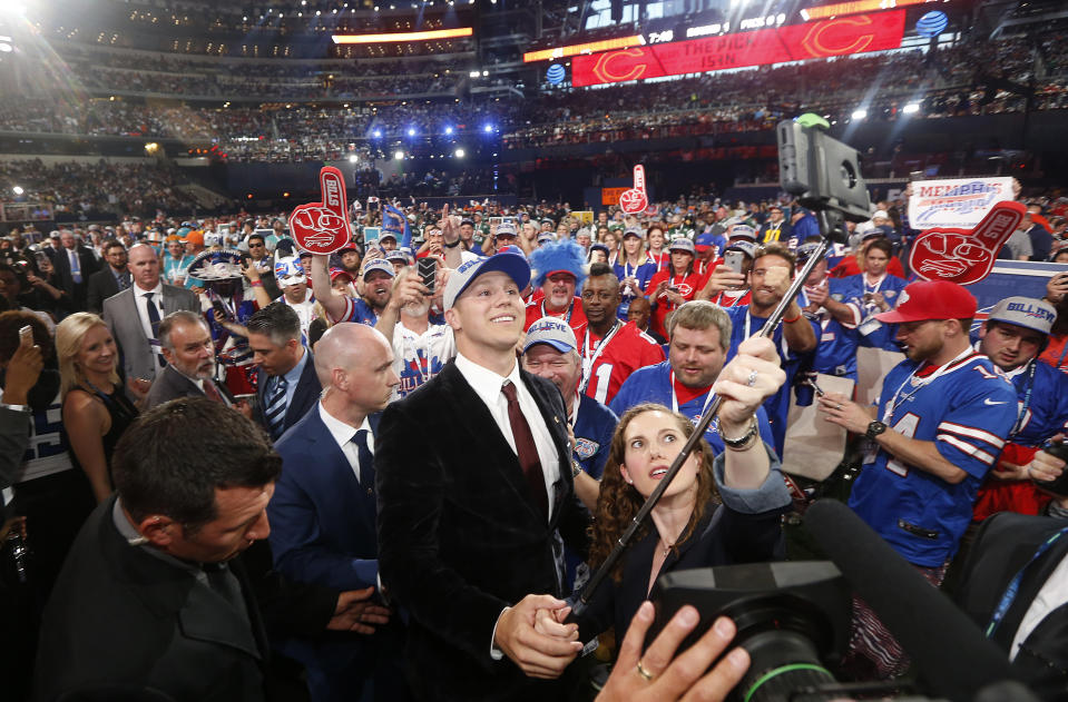 Wyoming’s Josh Allen, center, takes a selfie of himself with Buffalo Bills fans after being selected by the team during the first round of the NFL football draft. (AP)