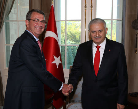 Turkish Prime Minister Binali Yildirim (R) meets with U.S. Defense Secretary Ash Carter in Ankara, Turkey, October 21, 2016. Mustafa Aktas/Prime Minister's Press Office/Handout via REUTERS