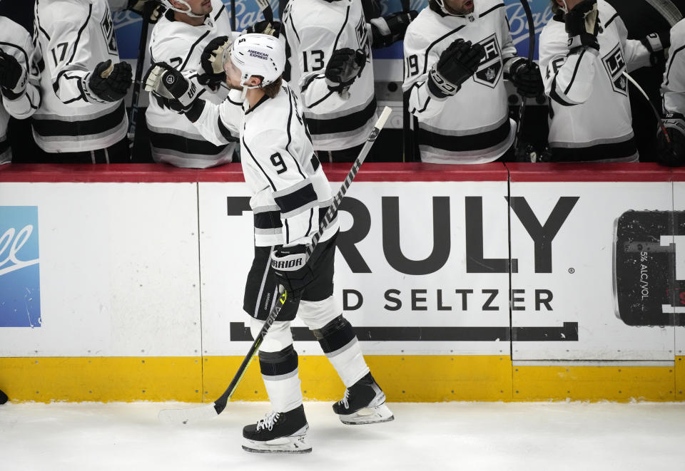 Los Angeles Kings right wing Adrian Kempe, front, is congratulated as he passes the team box after scoring a goal against the Colorado Avalanche in the first period of an NHL hockey game Thursday, March 9, 2023, in Denver. (AP Photo/David Zalubowski)