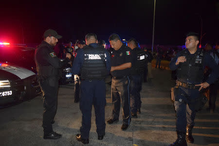 Policemen are seen outside the Siglo XXI immigrant detention center after a large group of Cubans, Haitians and Central Americans broke out and escaped the facilities, in Tapachula, Mexico April 25, 2019. REUTERS/Jose Torres