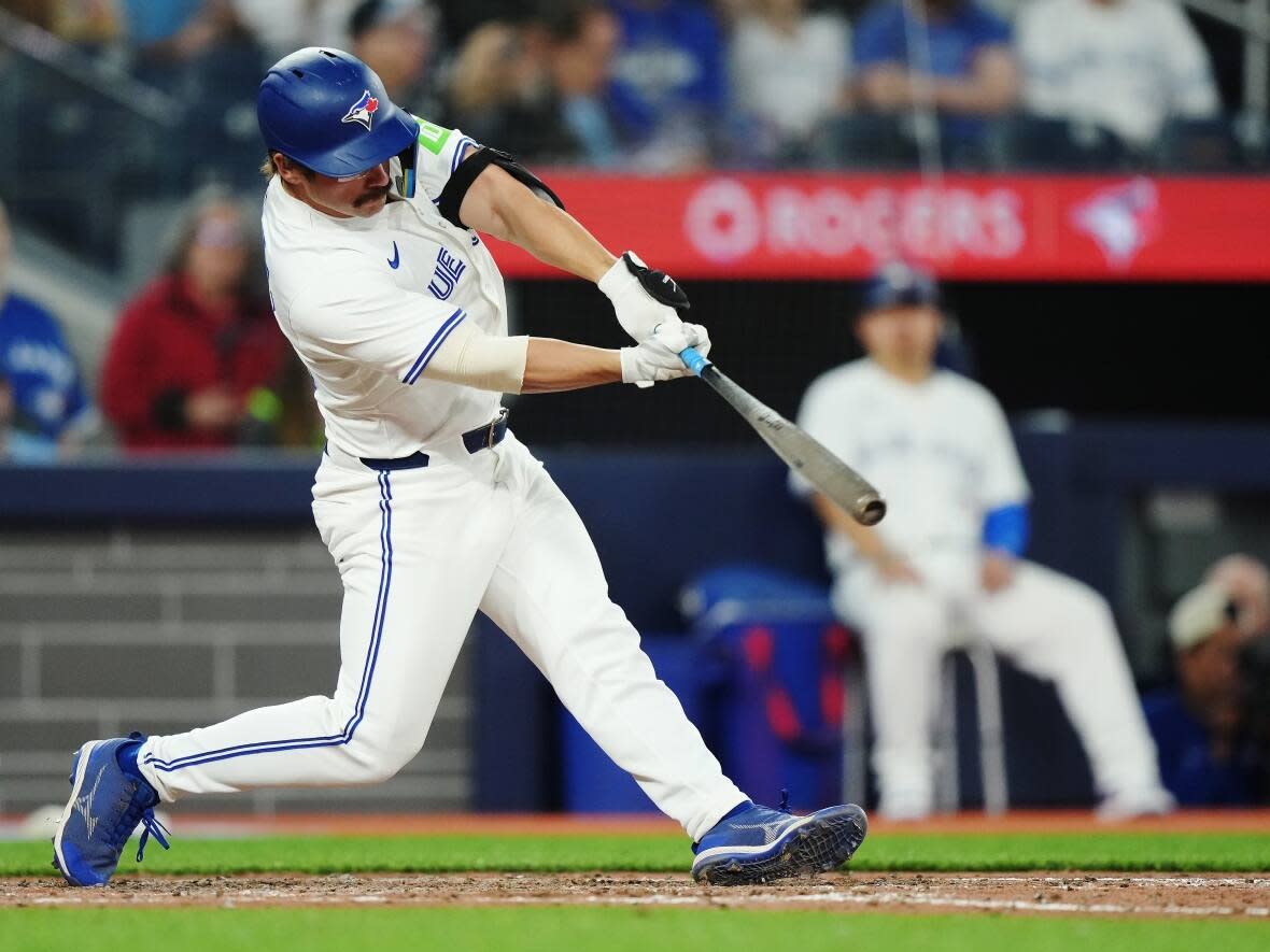 Toronto Blue Jays' Davis Schneider (36) hits a single against the Seattle Mariners during eighth inning American League MLB baseball action in Toronto on Monday. (Nathan Denette/The Canadian Press - image credit)