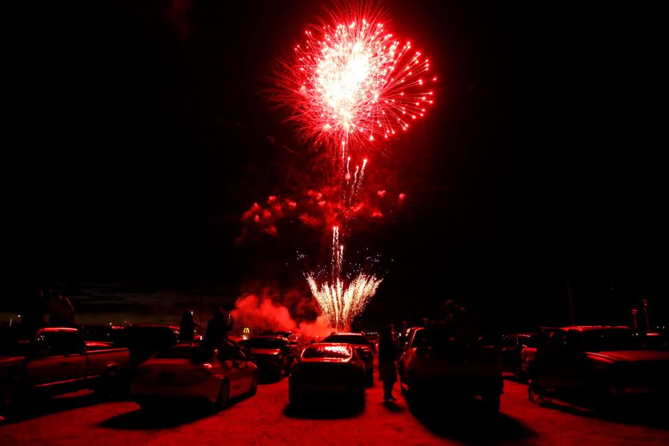 Spectators watch on July 1 fireworks light up the night sky in Shiprock. This is the second year the Navajo Nation marked the Fourth of July with the fireworks show series on the tribal land.