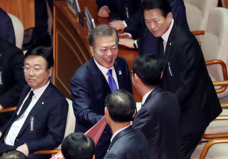 South Korean President Moon Jae-in smiles after delivering his speech on the 2018 budget bill during a plenary session at the National Assembly in Seoul, South Korea, November 1, 2017. Yonhap via REUTERS