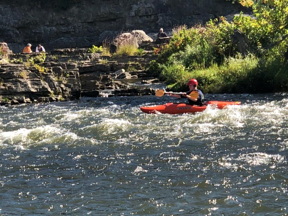 A kayaker takes a run on the Winooski River at The Salmon Hole  on Sunday, Sept. 29, 2019.