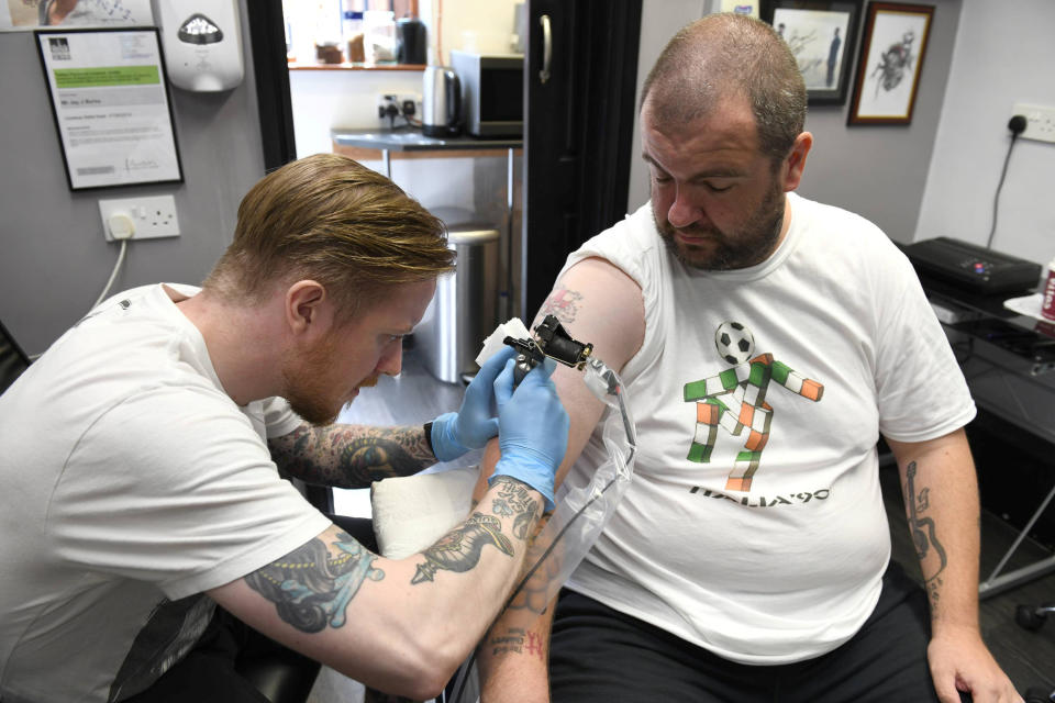 Jeff Holt gets the drawing tattoed in his arm…