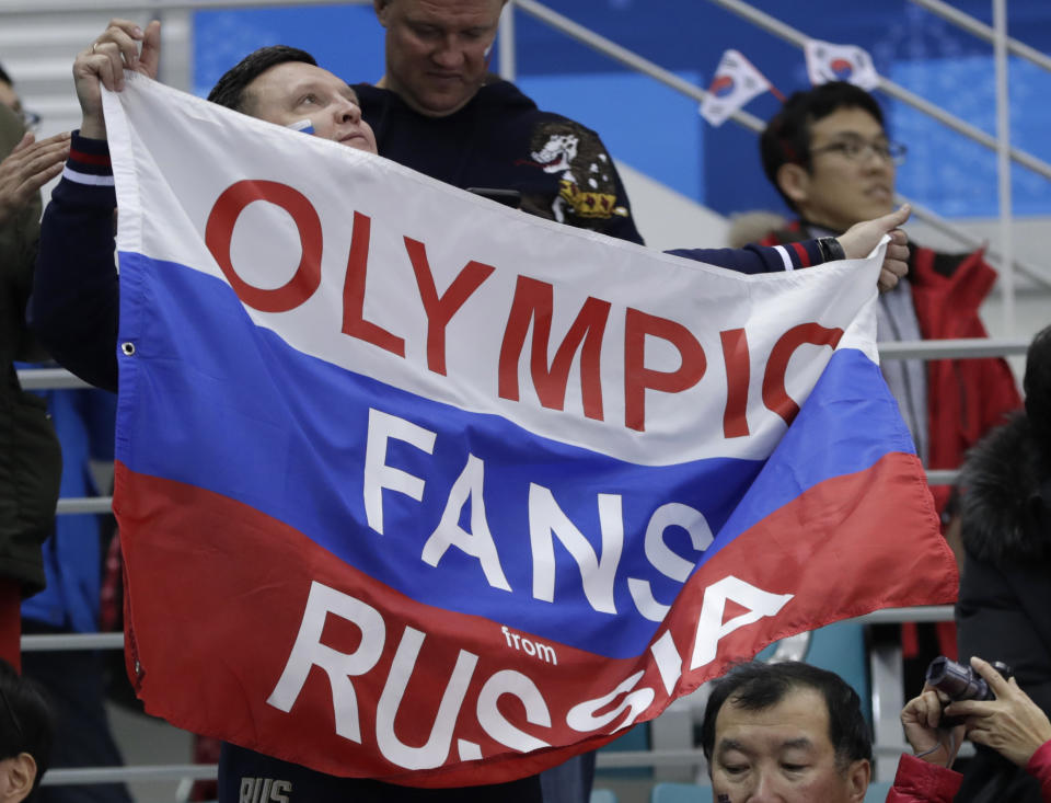 A fan holds up a flag as he cheers during the preliminary round of the men’s hockey game between the team from Russia and Slovenia at the 2018 Winter Olympics in Gangneung, South Korea, Friday, Feb. 16, 2018. (AP Photo/Julio Cortez)