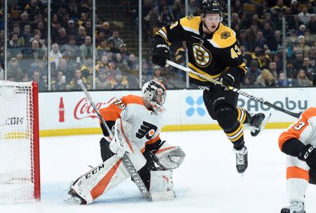Jan 31, 2019; Boston, MA, USA; Boston Bruins center Danton Heinen (43) jumps out of the way of a shot in front of Philadelphia Flyers goaltender Carter Hart (79) during the third period at TD Garden. Mandatory Credit: Bob DeChiara-USA TODAY Sports