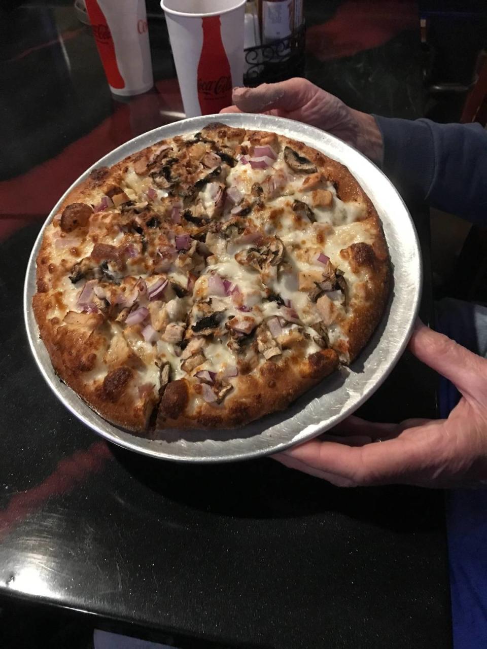 An 8-inch mini pizza from Luigi’s Pizza in Cambria holds a lot of white sauce, grilled chicken, vegetables, roasted garlic and plenty of melted mozzarella cheese.
