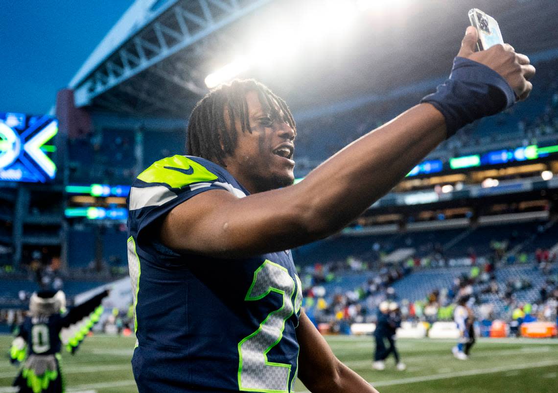 Seattle Seahawks cornerback Tariq Woolen (27) talks on the phone after defeating the Los Angeles Rams in overtime after an NFL game at Lumen Field in Seattle, Wash. on Jan. 8, 2023. The Seahawks defeated the Rams in overtime 19-16.