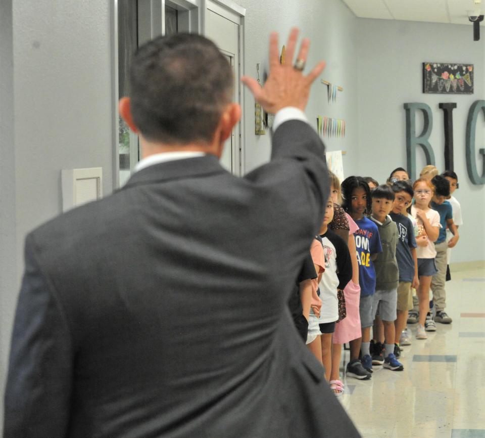 WFISD Superintendent Donny Lee waves goodbye to students at West Foundation Elementary School on the first day of school for WFISD students on Wednesday, August 17, 2022.