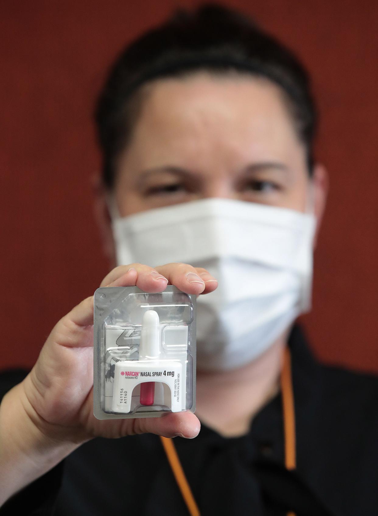 Bethany Perkowski , Environmental Health Director for the Massillon Health Department holds a 4 mg bottle of Narcan.