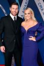 <p>The GRAMMY-winning country singer met her NHL player husband after they were set up on a blind date by friends...despite the fact they lived in different countries at the time.</p><p>'I mean, can I make dating more difficult?' Underwood said on<a href="http://ew.com/article/2012/09/28/carrie-underwood-mike-fisher-behind-the-music/" rel="nofollow noopener" target="_blank" data-ylk="slk:VH1's;elm:context_link;itc:0" class="link "> VH1's</a> <a href="https://www.countryliving.com/life/entertainment/a41996/carrie-underwood-mike-fisher-love-story/" rel="nofollow noopener" target="_blank" data-ylk="slk:Behind the Music;elm:context_link;itc:0" class="link ">Behind the Music</a>. 'Let's get a hockey guy who lives in another country. Awesome.'</p><p>It worked out, and the couple married in 2010 and have two children together.<br></p>