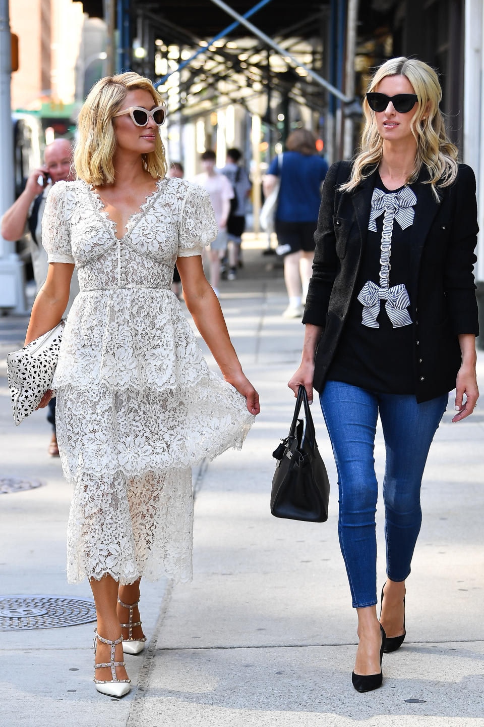 Paris and Nicky Hilton walk the streets of Broadway in New York City. - Credit: Robert O'Neil / SplashNews.com