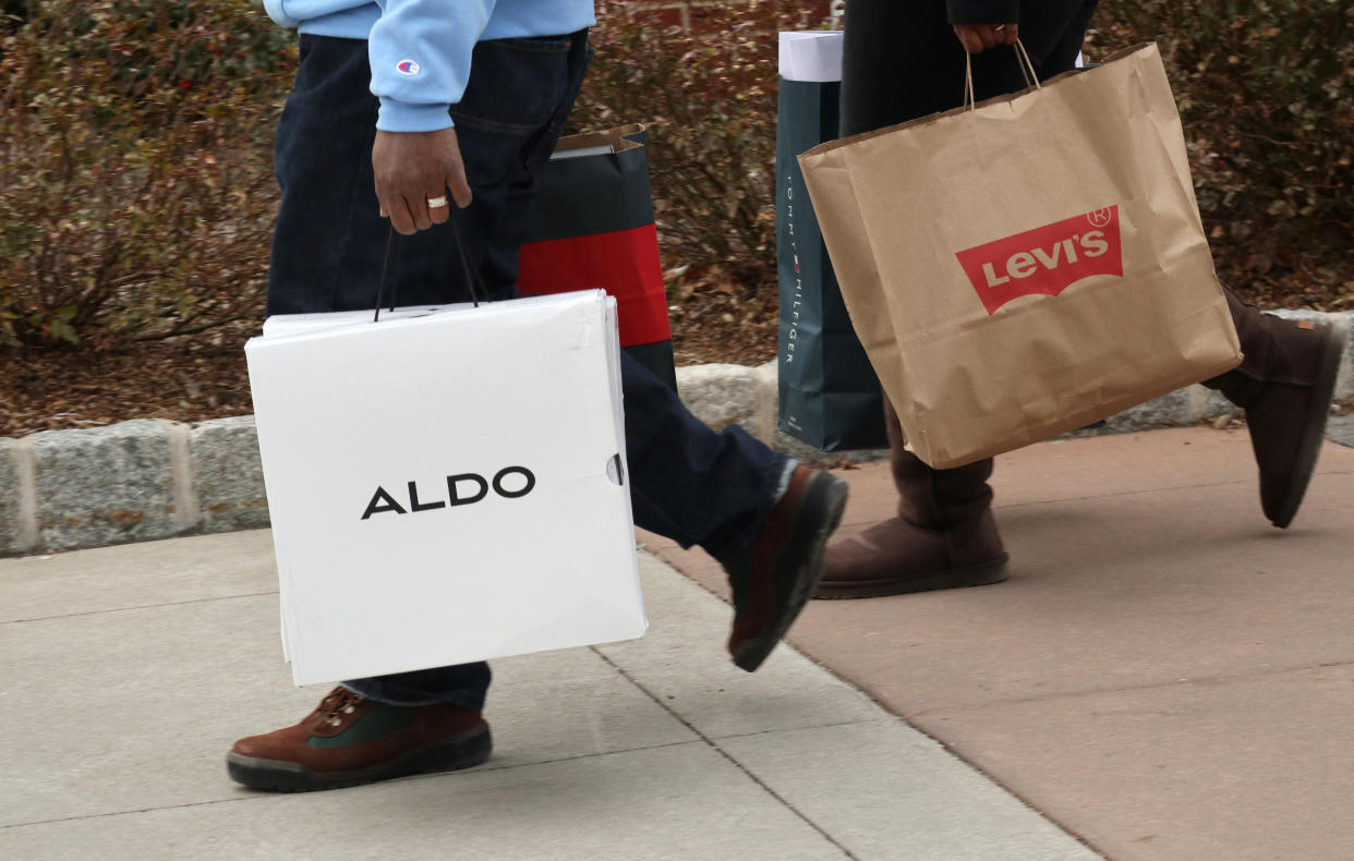 CENTRAL VALLEY, NY - NOVEMBER 17:  People carry Aldo and Levis bags at the Woodbury Common Premium Outlets shopping mall on November 17, 2019 in Central Valley, New York. (Photo by Gary Hershorn/Getty Images)