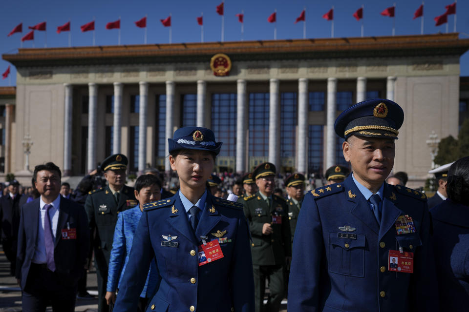 Military officers and delegates leave the Great Hall of the People after attending the second plenary session of the National People's Congress (NPC) in Beijing, Friday, March 8, 2024. (AP Photo/Andy Wong)