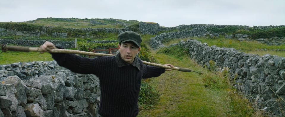 Barry Keoghan stands in a field