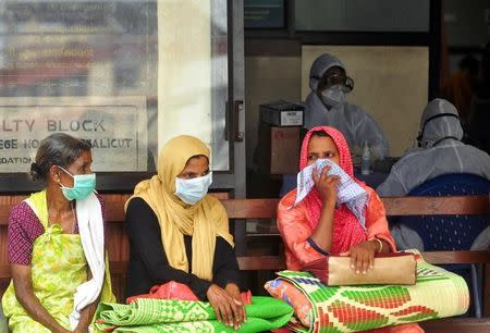 FILE PHOTO: People wear masks as they wait outside a casualty ward at a hospital in Kozhikode in Kerala May 23, 2018. REUTERS/Stringer/File Photo