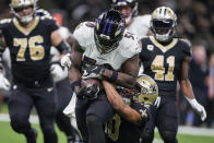 Baltimore Ravens linebacker Justin Houston (50) runs with his interception as he is tackled by New Orleans Saints wide receiver Tre'Quan Smith (10) in the second half of an NFL football game in New Orleans, Monday, Nov. 7, 2022. (AP Photo/Gerald Herbert)