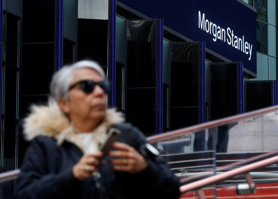 A woman takes photos by the Morgan Stanley building in Times Square in New York City, New York U.S., February 20, 2020. REUTERS/Brendan McDermid