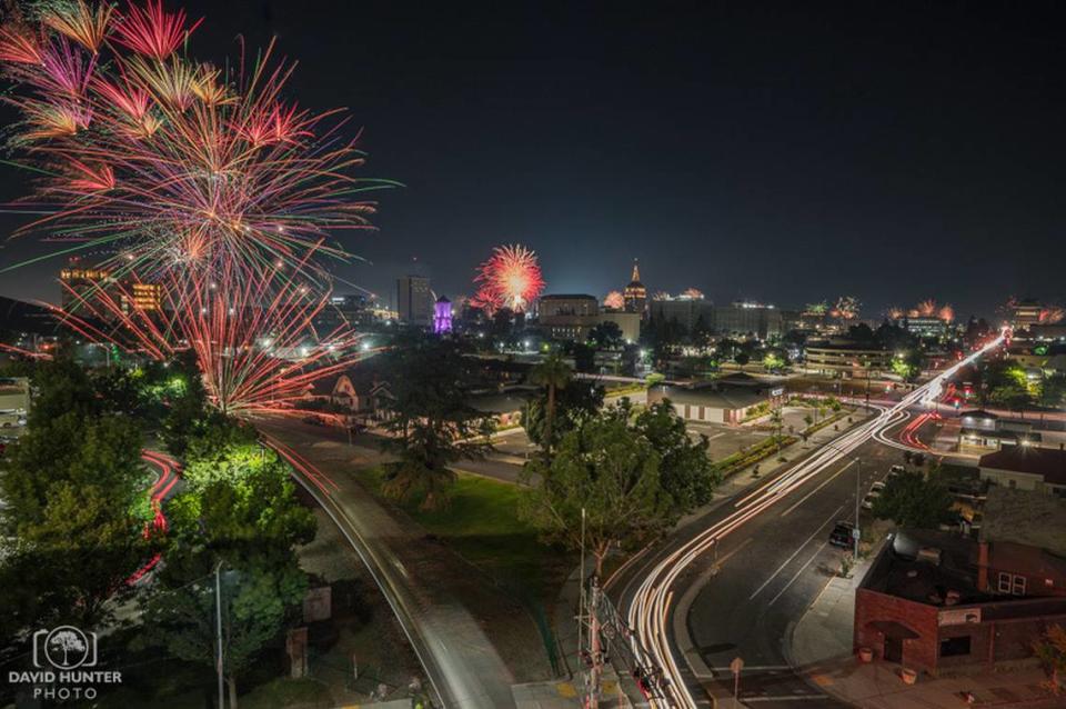 Fireworks displays, some illegal and some from Chukchansi Park, light up the evening skies above downtown Fresno on July 4th, 2023, as captured from the Community Regional Medical Center parking garage by local photographer David Hunter.