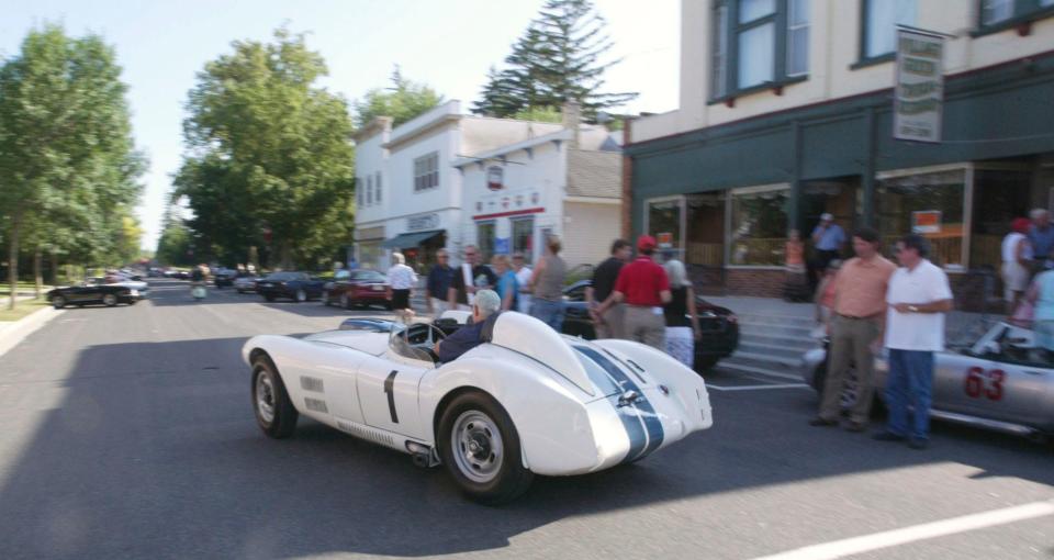 A Cunningham C4R, the very car John Fitch drove winning a race in the 1950s, drives through downtown Elkhart Lake July 13, 2006 during a dedication of a historic sign denoting that road racing roared through the village in 1950 and 1951.