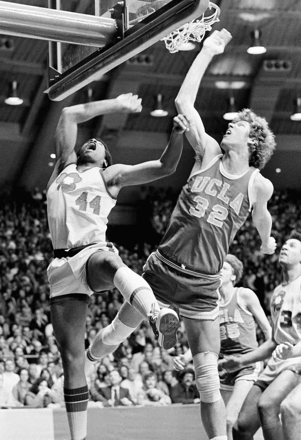 FILE - UCLA's Bill Walton (32) fights Notre Dame's Adrian Dantley (44) for a rebound during an NCAA college basketball game in South Bend, Ind., Jan. 19, 1974. Notre Dame beat UCLA 71-70, ending UCLA's 88-game winning streak. (AP Photo/File)