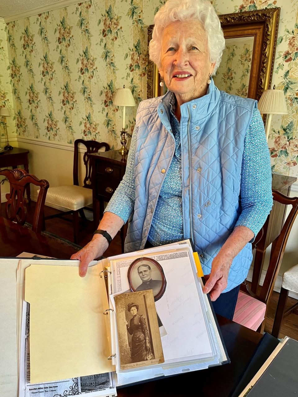 Susan Brackney holds up a scrapbook with pictures of her great-great-aunt Martha Henson, the namesake of soon-to-be-razed Henson Hall.