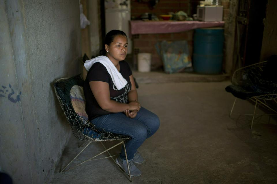 Marvelis Sinai, whose cousin Jhonny Godoy was shot to death outside his home by special agents, sits her cousin's living room in the La Vega neighborhood in Caracas, Venezuela, Tuesday, Feb.19, 2019. "I'm going to continue demonstrating because I learned it from my cousin," said Sinai, who works for an opposition politician who hands out free food in the slums. "He died so we can have a free Venezuela." (AP Photo/Ariana Cubillos)