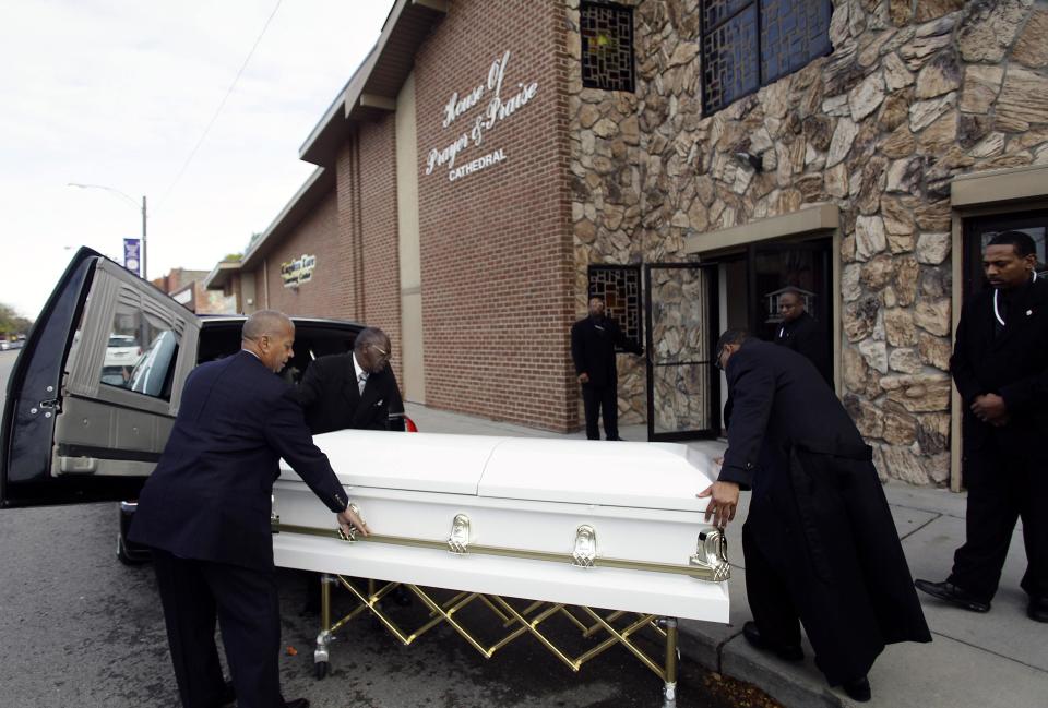 The casket for shooting victim Renisha McBride is removed from a hearse before her funeral service in Detroit