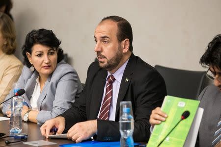 Syria's main opposition High Negotiations Committee (HNC) leader Nasr al-Hariri (C) attends a new round of negotiation with UN Special Envoy of the Secretary-General for Syria Staffan de Mistura during the Intra Syria talks, at Palais des Nations in Geneva, Switzerland July 14, 2017. REUTERS/Xu Jinquan/Pool