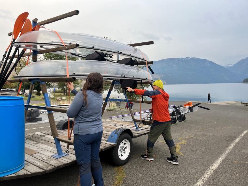 Samantha Shoffner, 18, and Joshua Shoffner lift a kayak off of a trailer in the parking lot at the north end of Wallowa Lake.