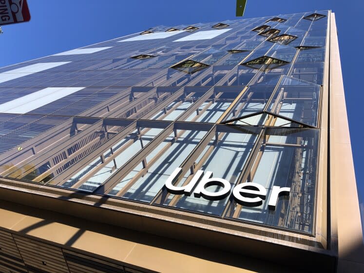 A view looking up towards Uber's facade shows accordion windows that are partially open