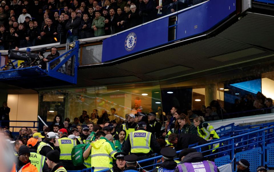 Medical staff attend to a Leeds fan after a fall from the top tier