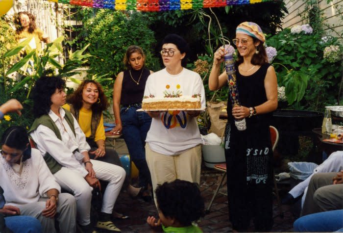 My first birthday in 1992. Mama Flavia is lighting my birthday candle while Mama Lu is holding the cake. The candle is one that is carried in the processions of El Señor de los Milagros, the most revered Catholic symbol in Perú. The vast majority of my mother’s friends and their children were present. Friends from Mexico, Venezuela, Colombia, Argentina, Italy, Ecuador, Peru. It was a big celebration and my mothers hired a clown. <span class="copyright">Quetzal Maucci</span>