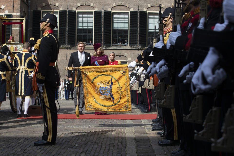 Dutch King Willem-Alexander and Queen Maxima salute the coat of arms after arriving in a horse-drawn carriage outside the Knight's Hall in The Hague, Netherlands, Tuesday, Sept. 17, 2019, for a ceremony marking the opening of the parliamentary year with a speech by King Willem-Alexander outlining the government's budget plans for the year ahead. (AP Photo/Peter Dejong)