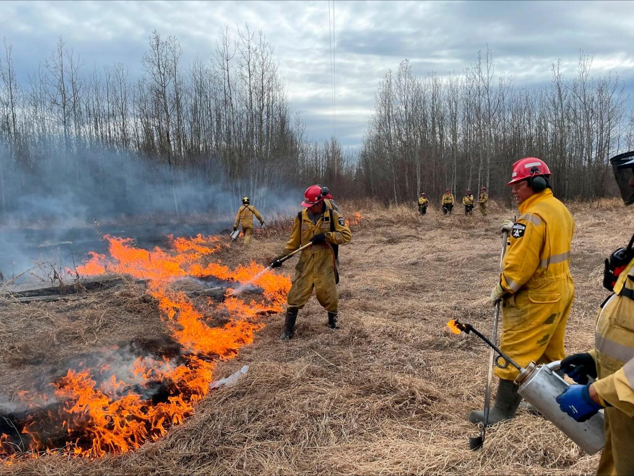 Wildfire firefighters do controlled burns in Alberta during Canada's record wildfire season in the summer of 2023.