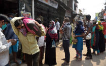 MUMBAI, INDIA - MARCH 25: Mumbaikar come out food items at Dharavi during restrictions on citizens' movement on account of Section 144 due to COVID 19 pandemic, on March 25, 2020 in Mumbai, India. Prime Minister Narendra Modi on Tuesday announced complete lockdown of the entire country, as part of the governments stringent efforts to tackle coronavirus disease Covid-19. This lockdown will be in place for 21 days and more stringent than Janta Curfew. Although, ration shops, groceries, fruits and vegetable shops, dairy and milk booths, meat and fish shops, animal fodder will remain open during the 21-day lockdown. (Photo by Satish Bate/Hindustan Times via Getty Images)