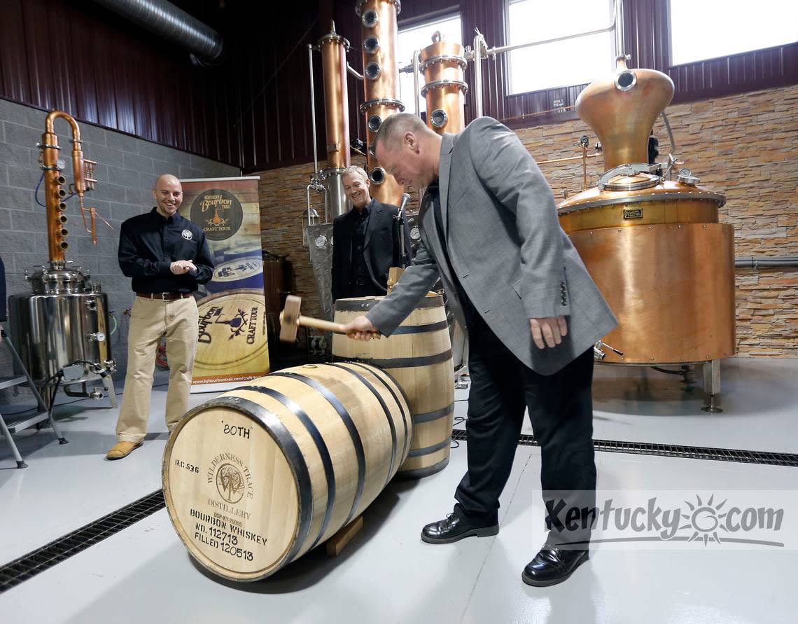 Distiller and co-owner Pat Heist tapped the ceremonial bung in a barrel of bourbon whiskey that was filled yesterday, during the grand opening ceremony at Wilderness Trace Distiller, 445 Roy Arnold Dr. in Danville, Ky., Friday, December 6, 2013. The distillery was subsequently renamed Wilderness Trail. Beside him was Jerod Smith, left, and fellow distiller and co-owner Shane Baker, middle.