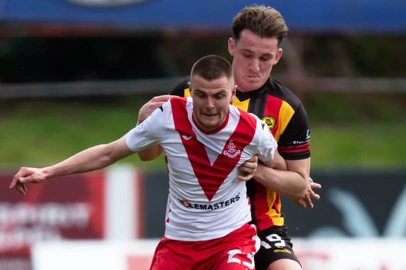 Airdrie's Gabby McGill tries to shield the ball from Thistle's Luke McBeth