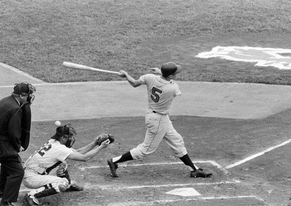 FILE - Baltimore Orioles third baseman Brooks Robinson, seeking his 1,000th major league hit, fouls the ball back past the head of Minnesota Twins catcher Jerry Zimmerman in the second inning of a baseball game against the Minnesota Twins, June 6, 1964 in Twin Cities, Minn. Robinson singled a couple of pitches later to reach the 1,000th. Robinson, whose deft glovework and folksy manner made him one of the most beloved and accomplished athletes in Baltimore history, has died, according to a joint announcement by the Orioles and his family Tuesday, Sept. 26, 2023. (AP Photo/Gene Herrick, File)