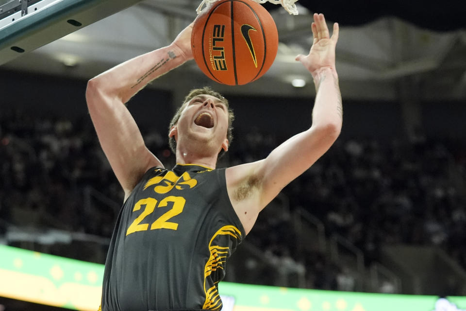 Iowa forward Patrick McCaffery dunks during the first half of an NCAA college basketball game against Michigan State, Tuesday, Feb. 20, 2024, in East Lansing, Mich. (AP Photo/Carlos Osorio)