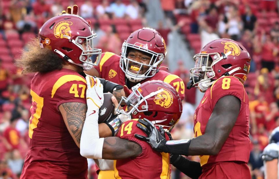 USC defensive lineman Stanley Ta'ufo'ou celebrates with teammates after returning a fumble for a touchdown.