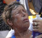 U.S. long-distance swimmer Diana Nyad, 64, reacts to a question, while lying on a stretcher, after completing her swim from Cuba to Key West, Florida, September 2, 2013. REUTERS/Andrew Innerarity