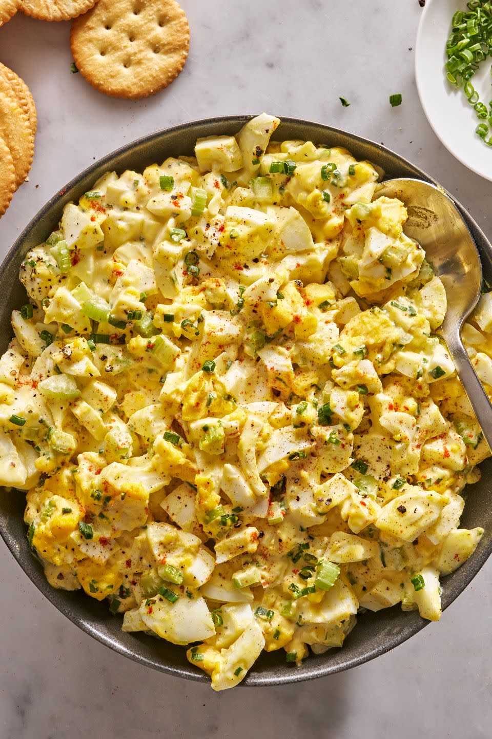 egg salad topped with chives and paprika