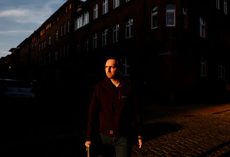 Artist Grzegorz Chudy, 36, walks in front of the house where his atelier is located in Nikiszowiec district in Katowice, Poland, November 7, 2018. REUTERS/Kacper Pempel