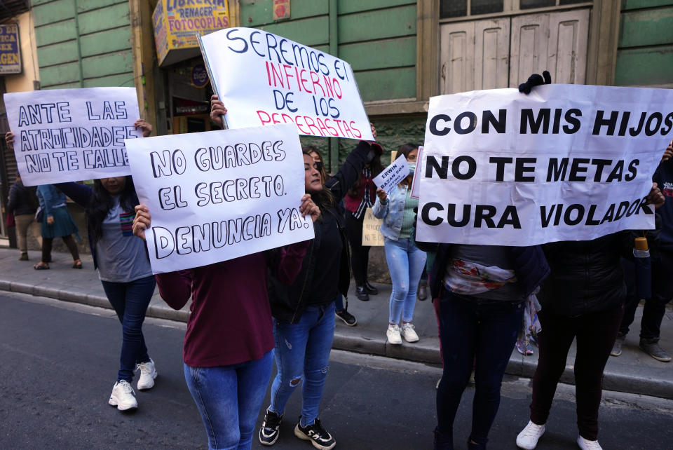 People protest with signs against sexual abuse by a priest outside the Bolivian Archbishopric office in La Paz, Bolivia, Friday, May 19, 2023. Milton Murillo, a Bolivian priest, has been remanded in custody on suspicion of abusing seminarians a decade ago, shortly after news broke of what has turned out to be the largest pedophilia scandal in the Andean country’s history, involving the deceased Jesuit priest. (AP Photo/Juan Karita)