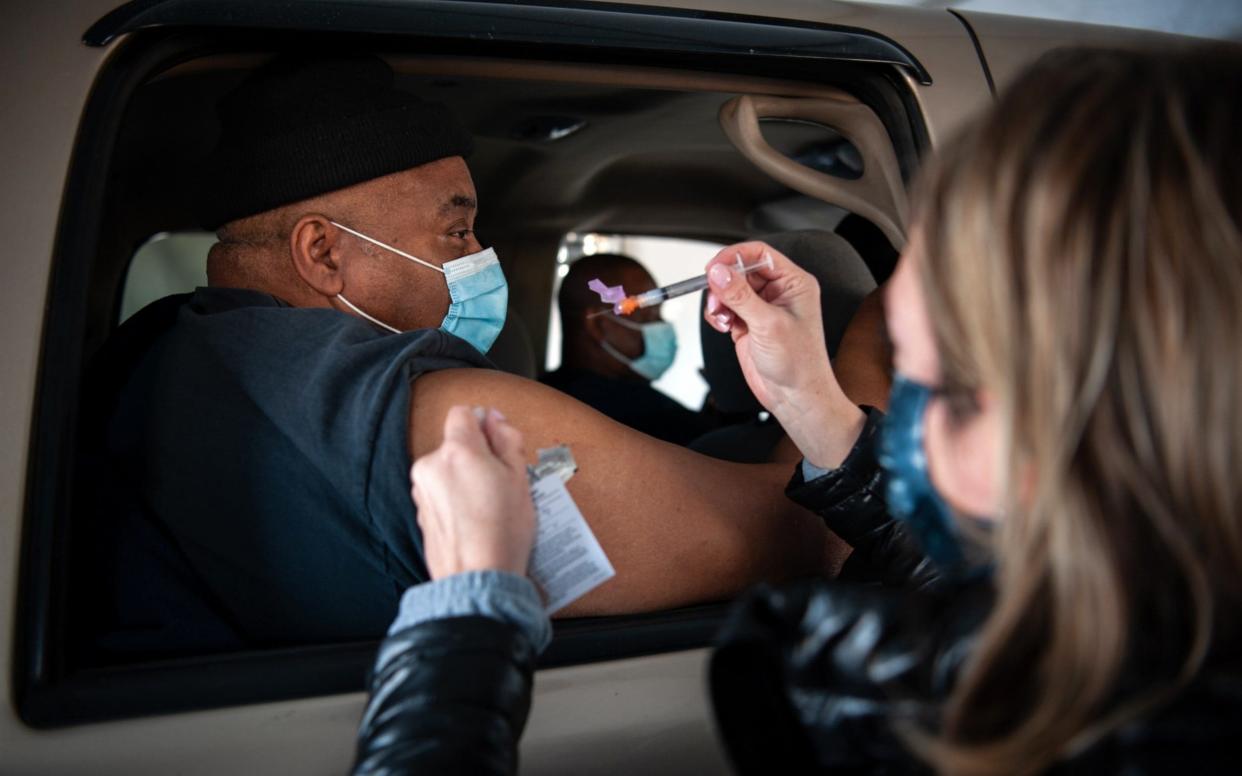 A healthcare worker administers a dose of the Moderna vaccine at a medical centre drive-thru site in Greenville, Mississippi - Bloomberg