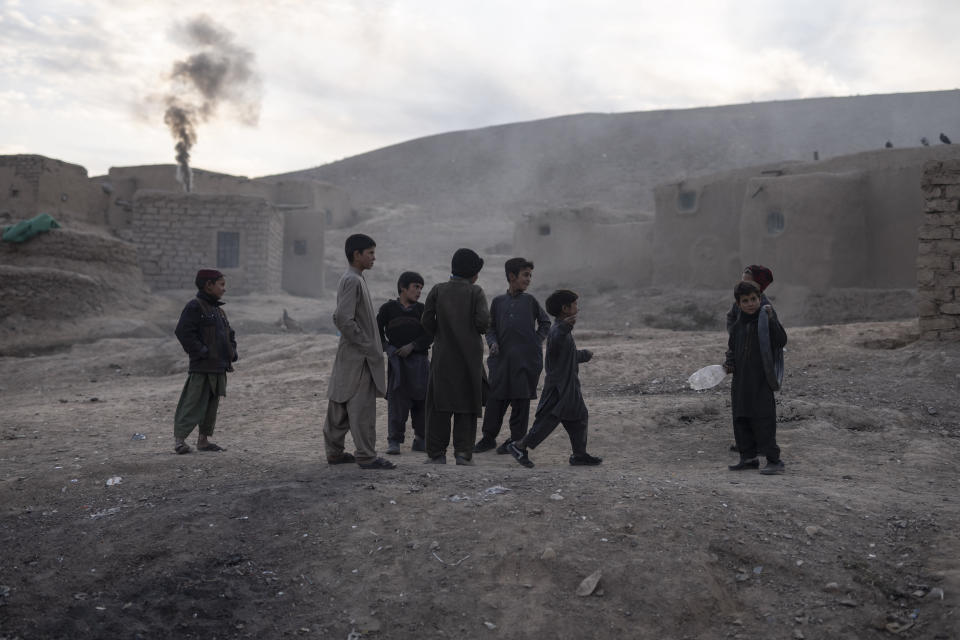 Children play in Kamar Kalagh village near Herat, Afghanistan, Saturday, Nov. 27, 2021. In the small village, life is shriveling away as residents try to squeeze out what little water is left from their dwindling well. (AP Photo/Petros Giannakouris)