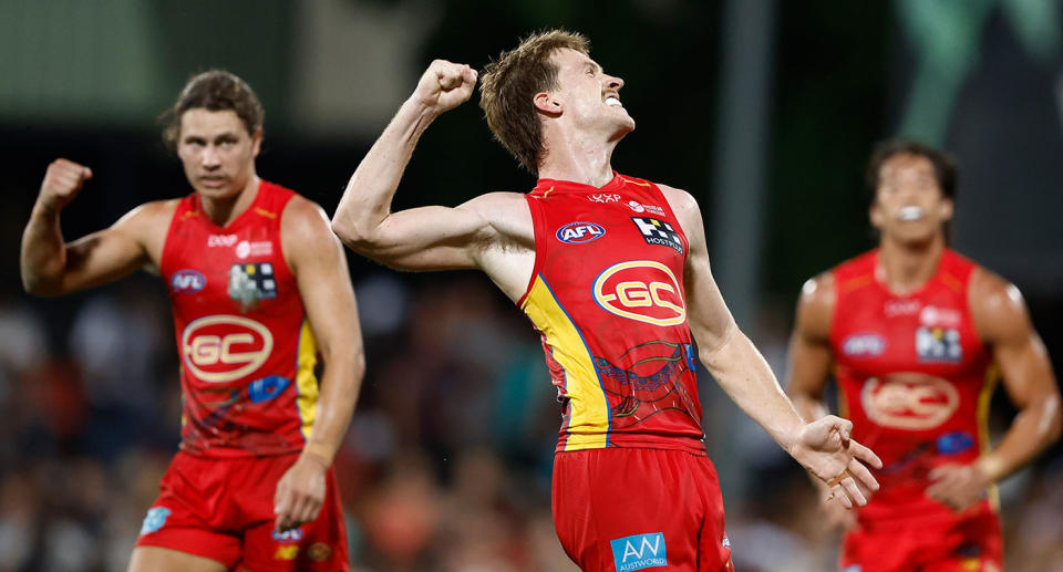 Seen here, Gold Coast Suns celebrate their win over Geelong in Darwin in the AFL. 